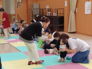講師の先生がこどもの顔をのぞき込んでいる写真です
